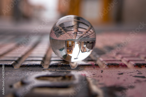 Crystal ball on the street, abstract reflections from the street