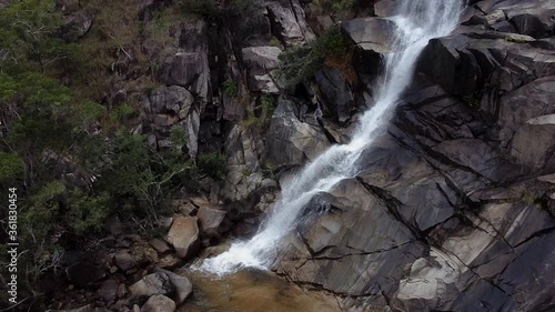 Davies Creek Falls Splashing On The Rocks In Davies Creek National Park, Queensland, Australia.  - aerial drone photo