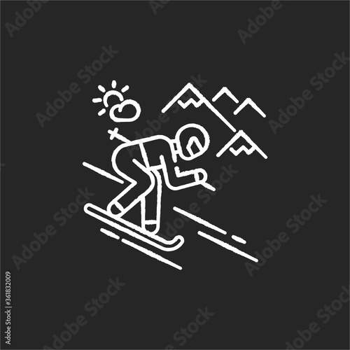 Skiing chalk white icon on black background. Winter vacation, seasonal extreme tourism. Active recreation at alpine ski resort. Sportsman skiing downhill isolated vector chalkboard illustration