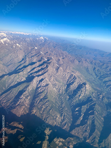 the view from the airplane, flying over the mountains area