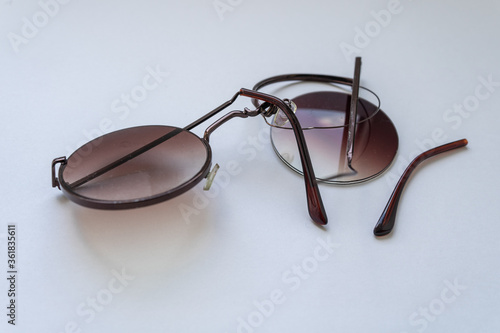 Broken sunglasses with round lenses