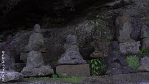 Old Carved Stone Buddhist Staties In Nihonji Shrine On Mount Nokogiriyama Japan - medium shot photo