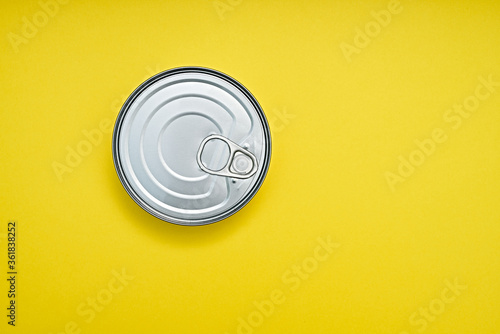 Tin can on a yellow background, top view