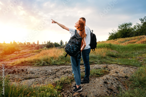 Local travel, Solo Explorers, Small Group tourist. Young couple going for hiking, walk in nature. Summer Outdoor Activities. Caucasian hiker couple enjoying themselves on summer vacation