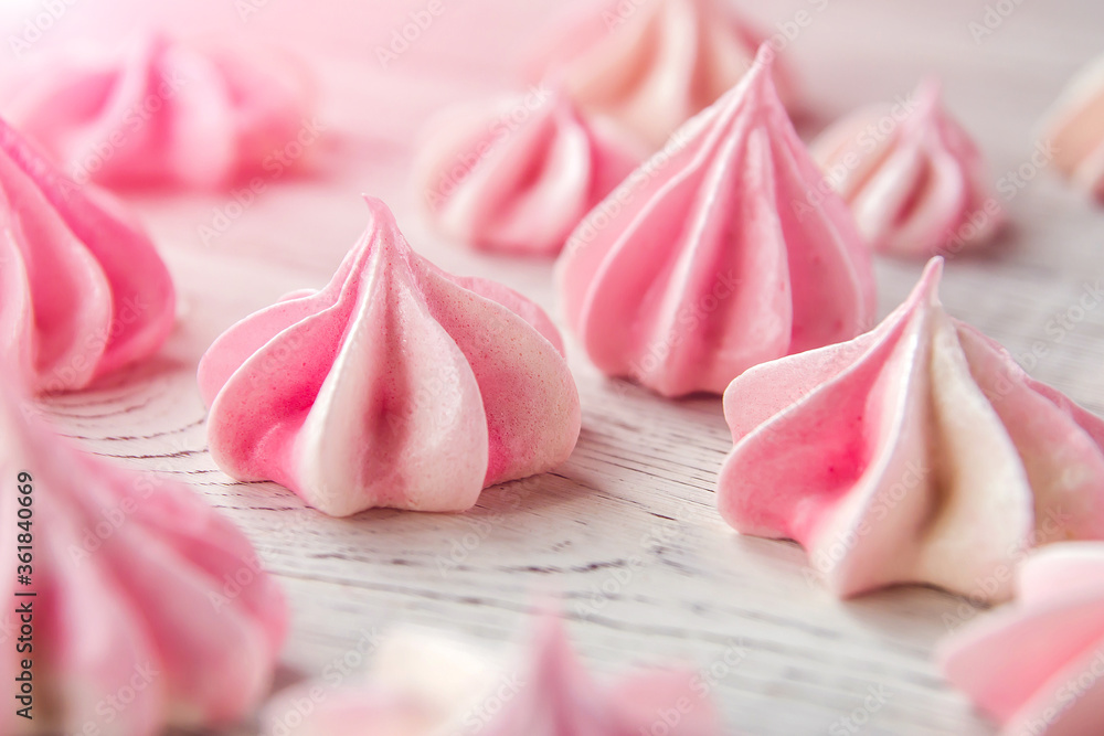 Little pink meringues on a white wooden table. Little pink meringues on a white wooden table.