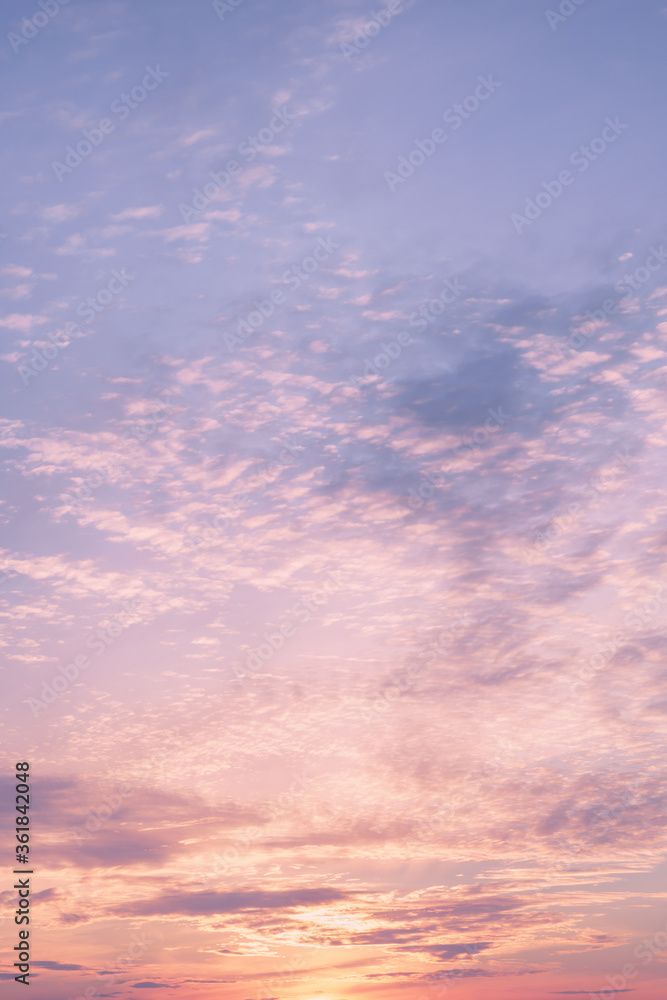 Dramatic cloudy pastel colored sunset sky