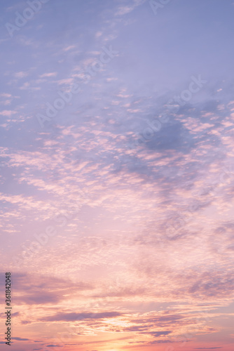 Dramatic cloudy pastel colored sunset sky