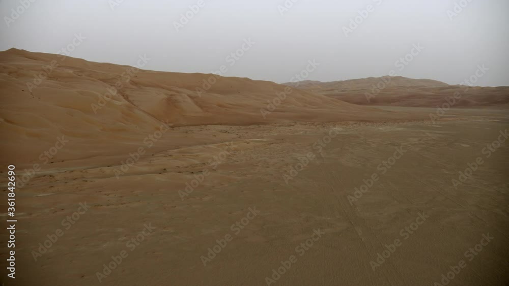 Amazing drone shot of desert A landscape of sand, harsh sunlight with the sand dune on the background Amazing drone shot of desert A landscape of sand, harsh sunlight with the sand dune on the background