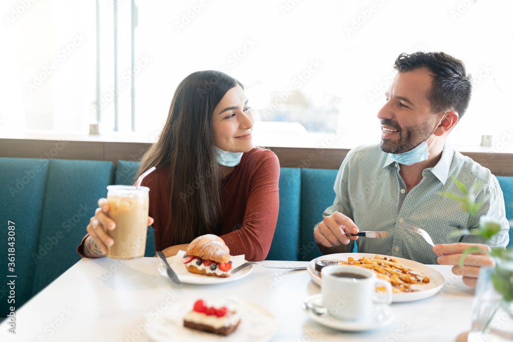 Couple Having Sweet Food Together At Cafe