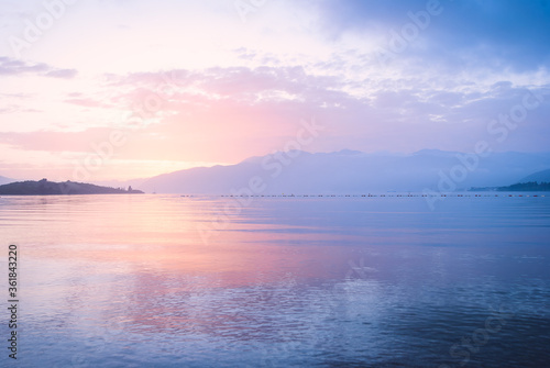 Pink and blu sunset in the sea on a background of mountains