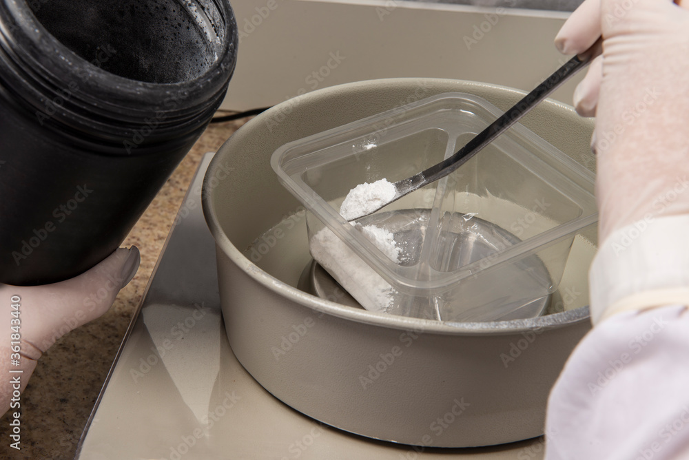 Fototapeta premium hands with protective gloves of a pharmacy professional handling medicine