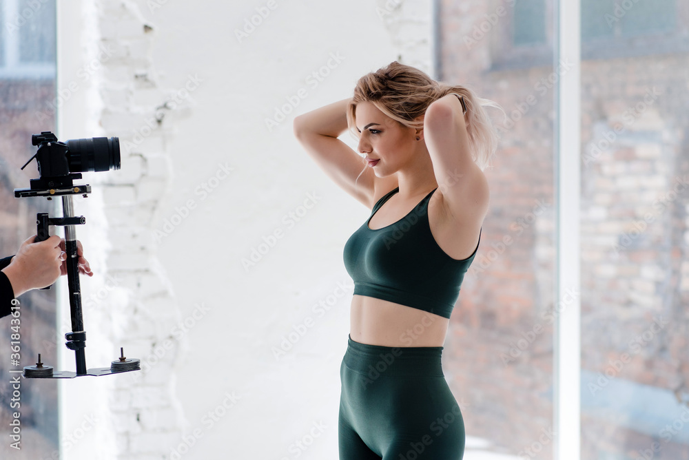Confident charming woman with athletic body posing on camera