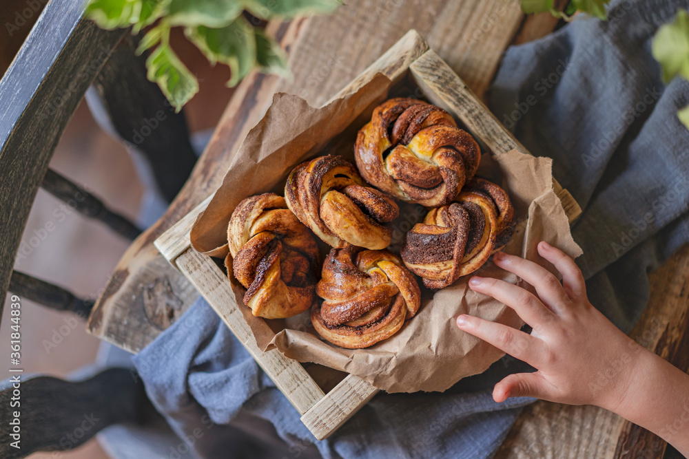 Cinnamon babka buns, homemade little babka pies in wooden box, rustic