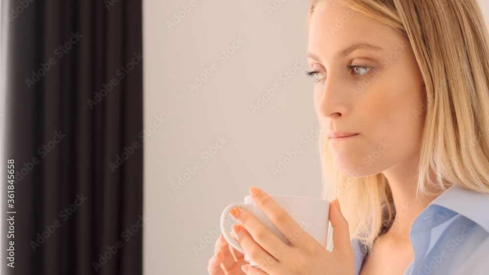 Close up beautiful girl dreaming while drinking coffee on kitchen at home