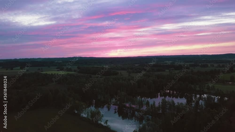Aerial, drone shot around a pond and trees, on the countryside of Bavaria, during dusk, in Germany Aerial, drone shot around a pond and trees, on the countryside of Bavaria, during dusk, in Germany