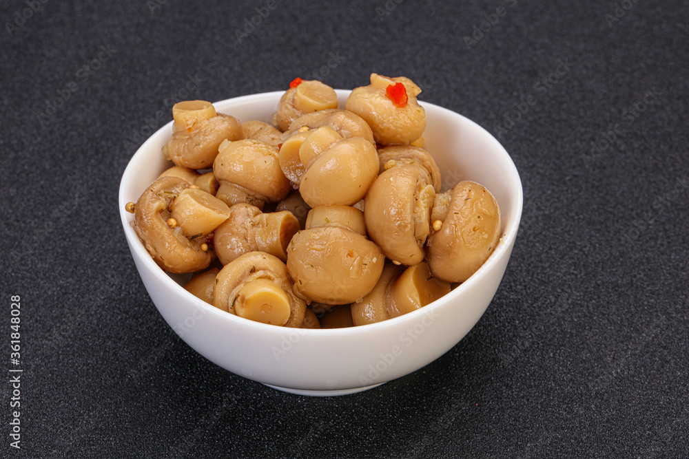 Pickled champignons in the bowl Pickled champignons in the bowl