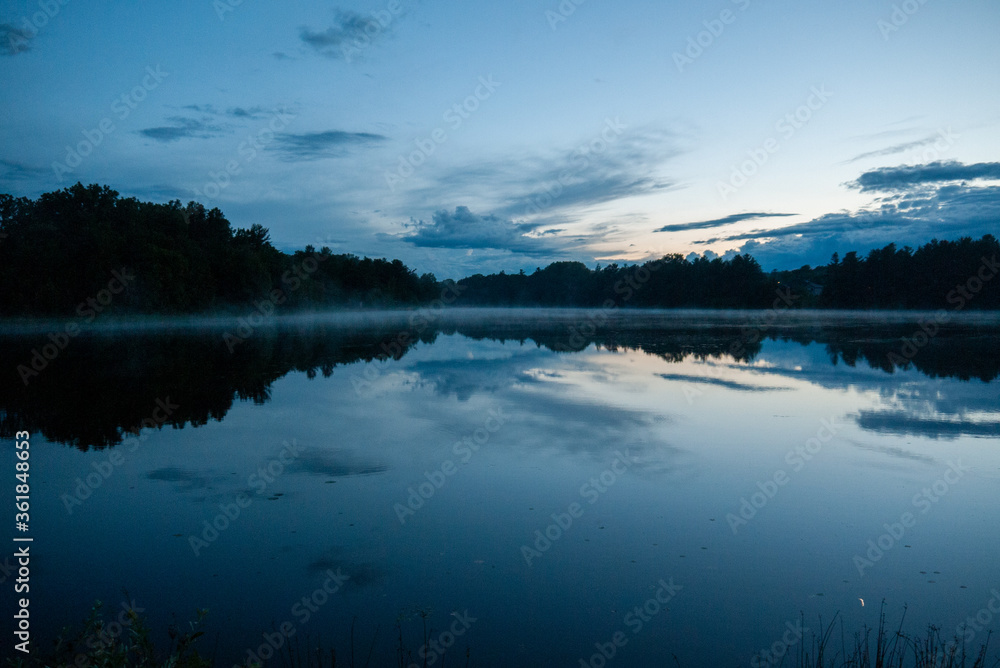 Dusk over a reflective calm lake