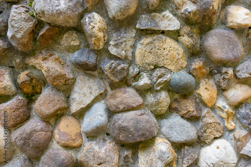 Fragment of an ancient wall made of natural stone