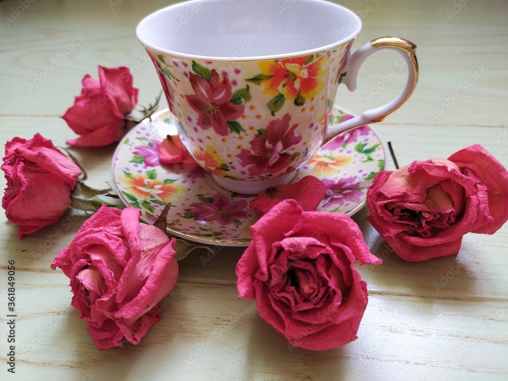 beautiful cup and saucer and dry pink roses beautiful cup and saucer and dry pink roses