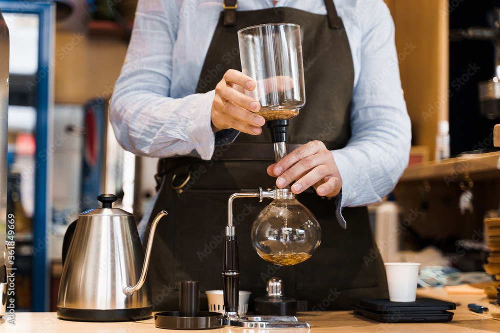 Syphon alternative method of making coffee. Barista prepare device for coffee brewing in cafe. Scandinavian method of coffee making.