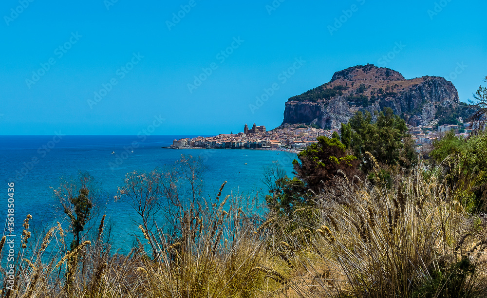 The picturesque town of Cefalu, Sicily dominated by the impressive Mesa behind the town in summer