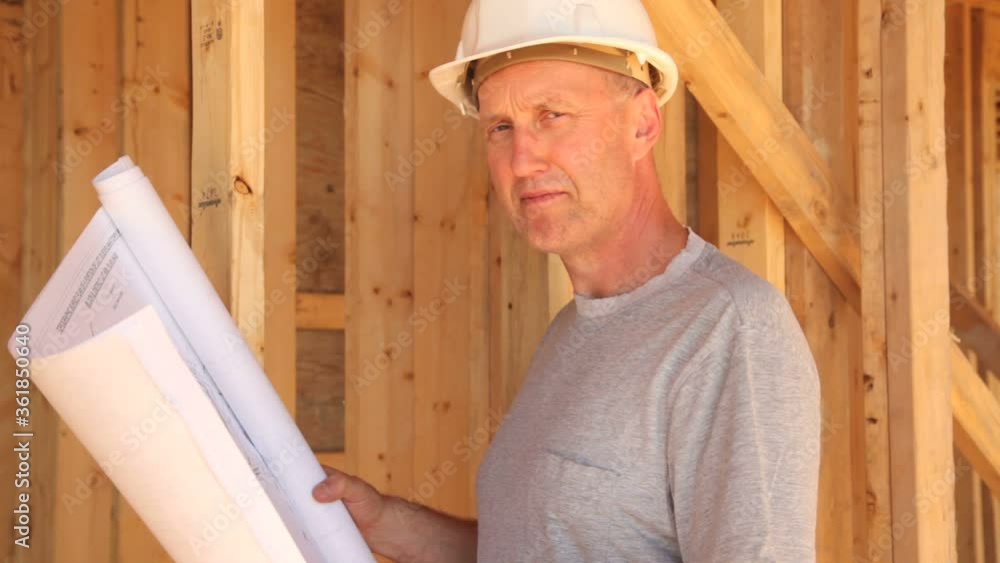Construction worker looking over blueprints. Construction worker looking over blueprints.