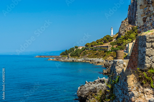 A view eastward down the shore of Cefalu, Sicily towards the lighthouse in summer
