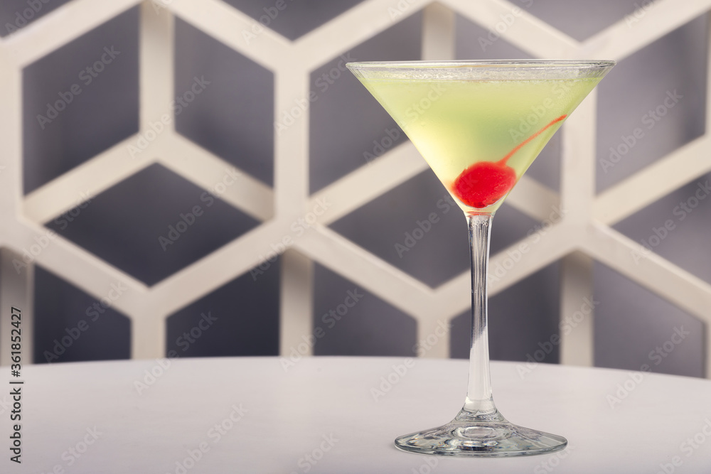 Fruit martini on white table with modern design bar background Fruit martini on white table with modern design bar background
