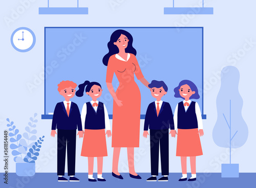 Happy children and teacher standing together in classroom. Class, classmates, pupils flat vector illustration. Primary school, education concept for banner, website design or landing web page