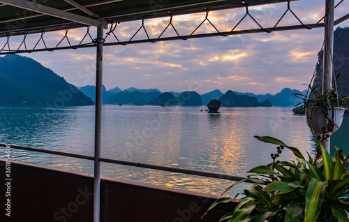 Fototapeta Naklejka Na Ścianę i Meble -  view from a tourist boat deck of the evening skies on Halong Bay among the limestone karsts
