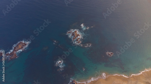 Aerial view of rocks in de blue sea, sunset in ocean pacific. México Oaxaca coast.