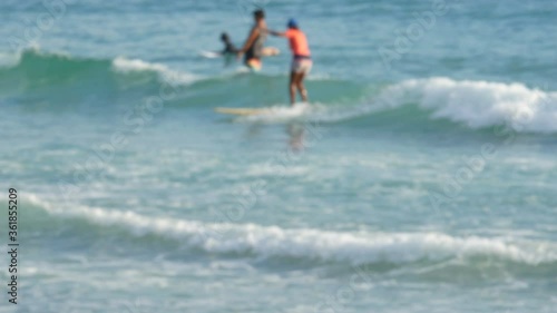 blur surfers with surfboard on the sea in sunny day