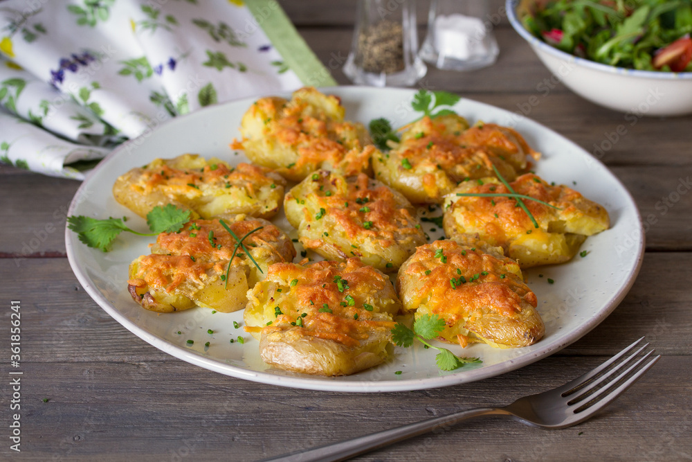 Smashed new baby potatoes with garlic and cheese. Healthy vegetarian food Smashed new baby potatoes with garlic and cheese. Healthy vegetarian food