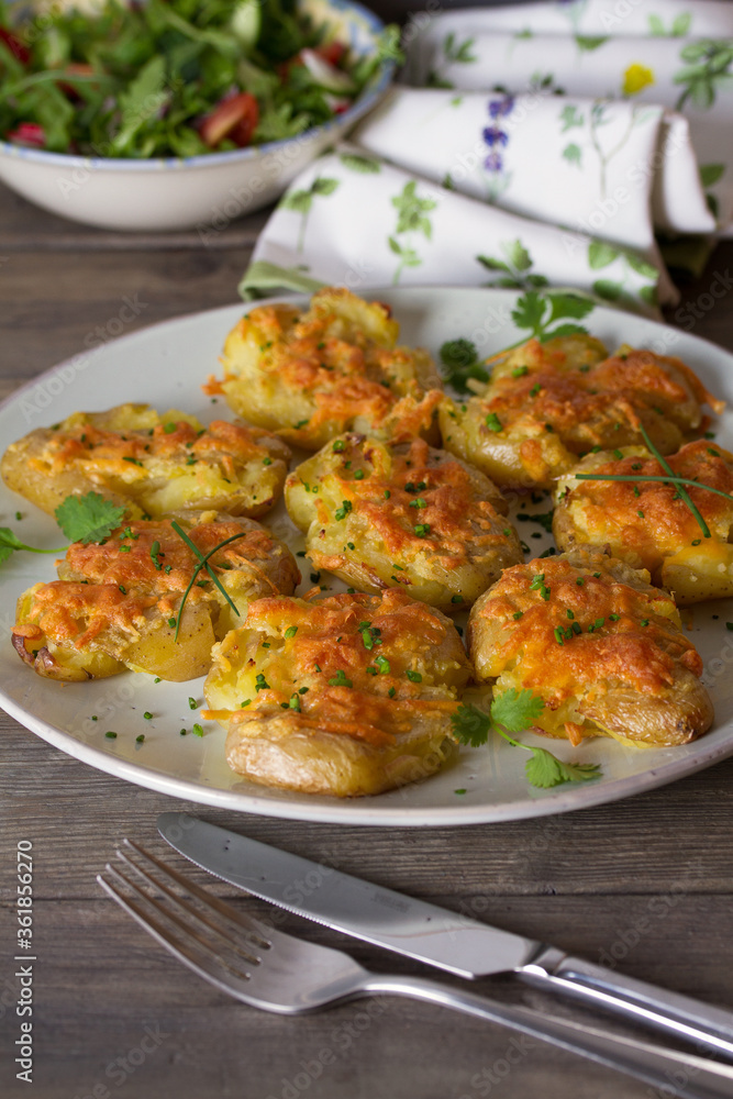 Smashed new baby potatoes with garlic and cheese. Healthy vegetarian food Smashed new baby potatoes with garlic and cheese. Healthy vegetarian food
