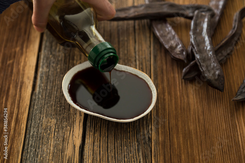 Traditional Harnup molasses on the wooden background.