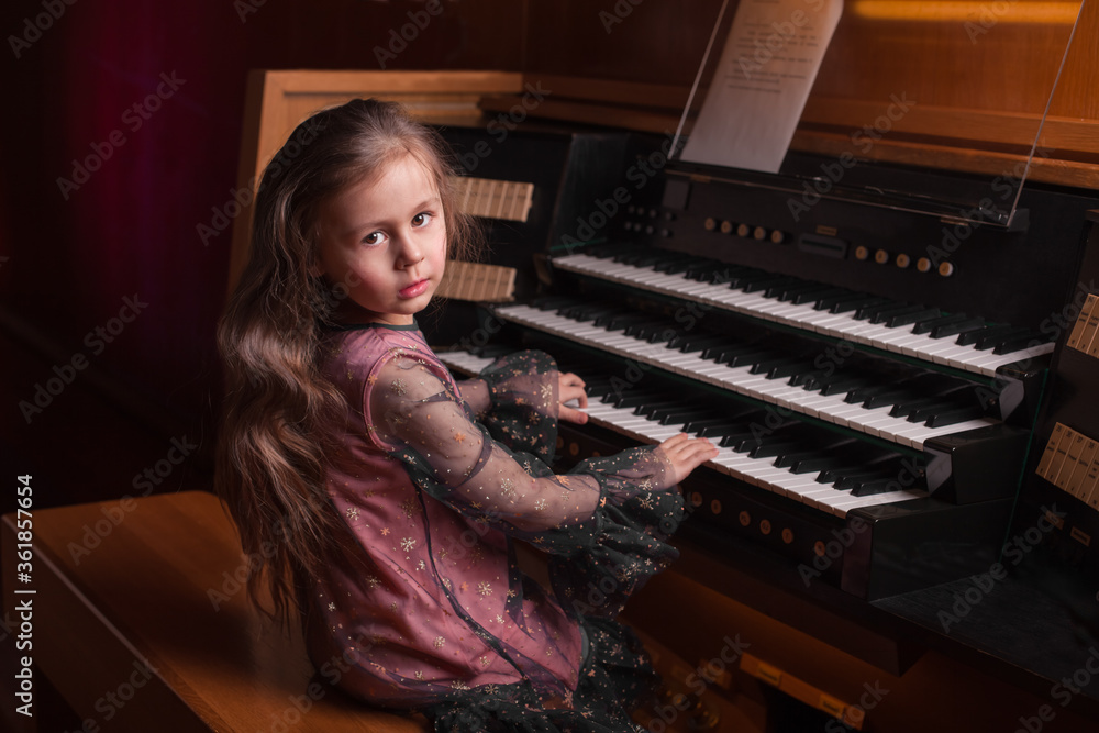 Little girl playing a pipe organ Stock Photo Adobe Stock