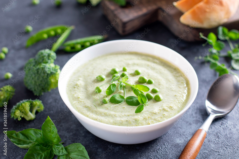 Summer cream soup with green fresh pea, shoots close-up on a concrete background Summer cream soup with green fresh pea, shoots close-up on a concrete background