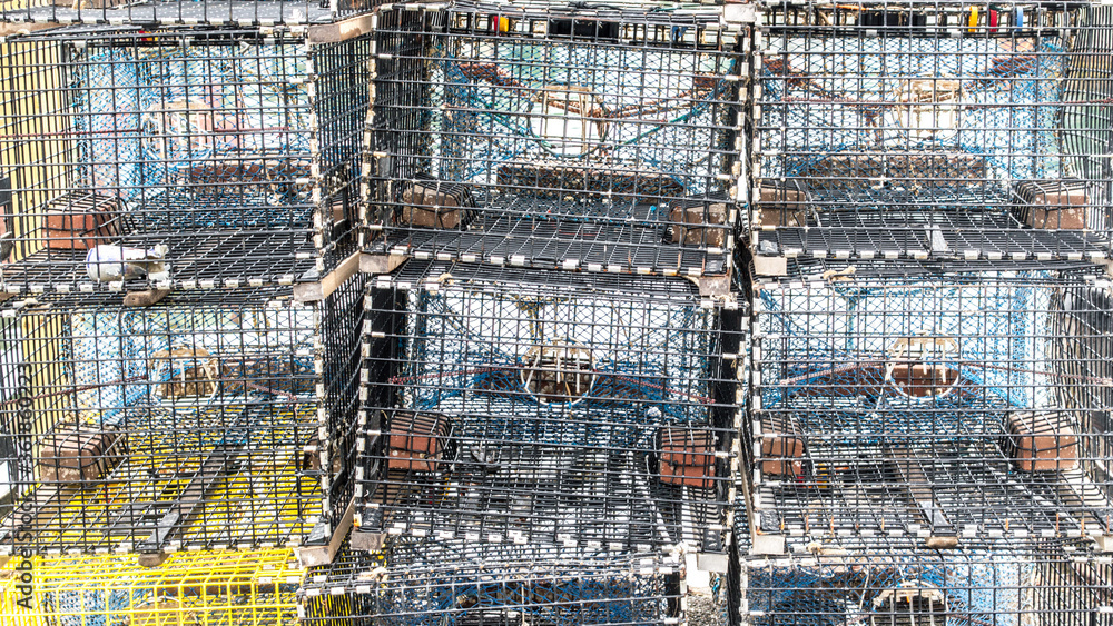 empty metal lobster traps stacked up on a wharf in Massachusetts