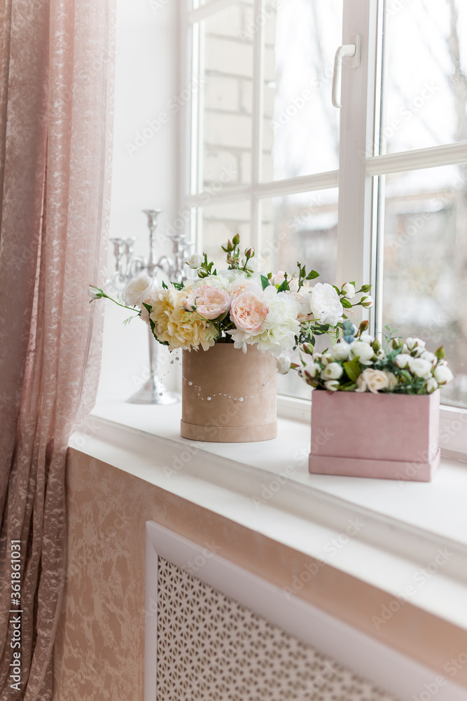 beautiful flowers in vases on old wooden windowsill