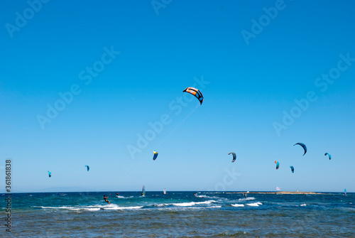 Athens, Greece, July 2020: Windsurfing and Kite Surfing on a very sunny day 