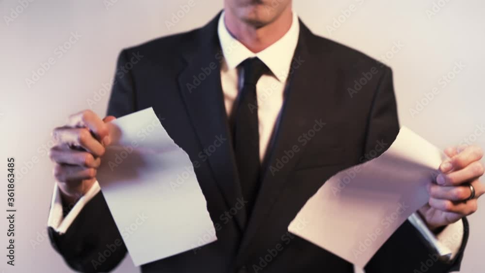 Hands of Businessman Ripping Up Paper Agreement Hands of Businessman Ripping Up Paper Agreement
