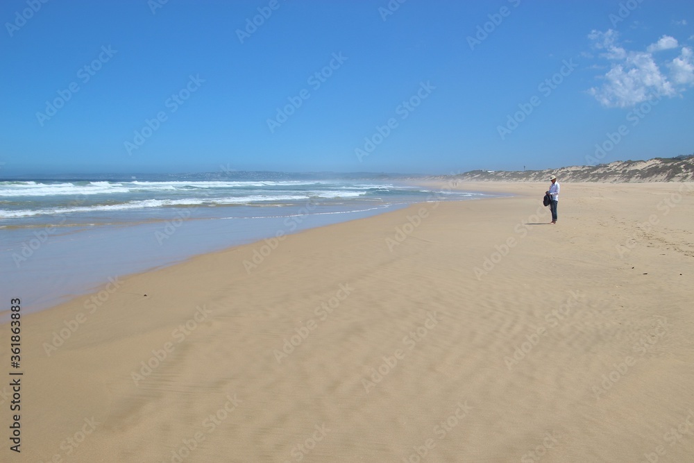 Wide sandy beach in Plettenberg Bay, by the Indian Ocean. Garden Route, South Africa, Africa.