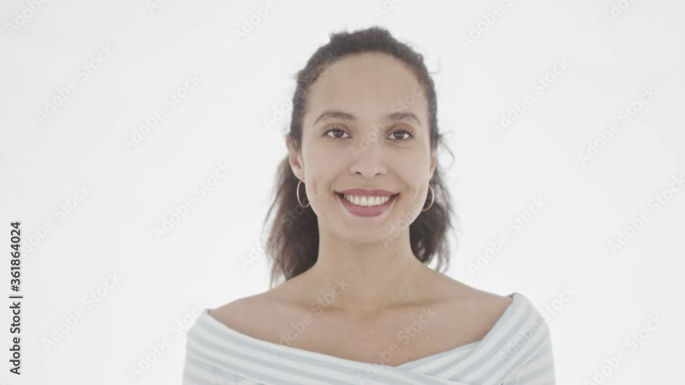 Good-looking broadly smiling brunette with clear brown eyes standing and looking joyfully at the distance. 360 degree tracking arc shot in 4K. Good-looking broadly smiling brunette with clear brown eyes standing and looking joyfully at the distance. 360 degree tracking arc shot in 4K.