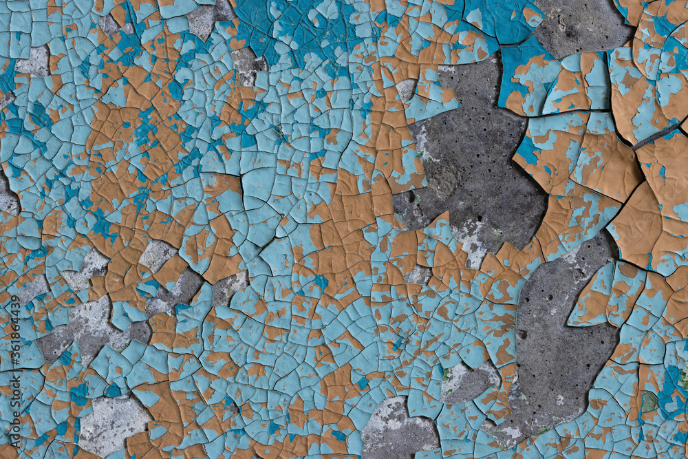 Peeling paint on the wall. Old concrete wall with cracked flaking paint. Weathered rough painted surface with patterns of cracks and peeling. High resolution texture for background and design. Closeup Peeling paint on the wall. Old concrete wall with cracked flaking paint. Weathered rough painted surface with patterns of cracks and peeling. High resolution texture for background and design. Closeup