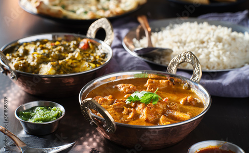 indian chicken tikka masala curry and saag paneer curries on table top