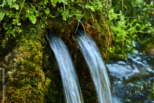 Fountain in a rock with two water pipes