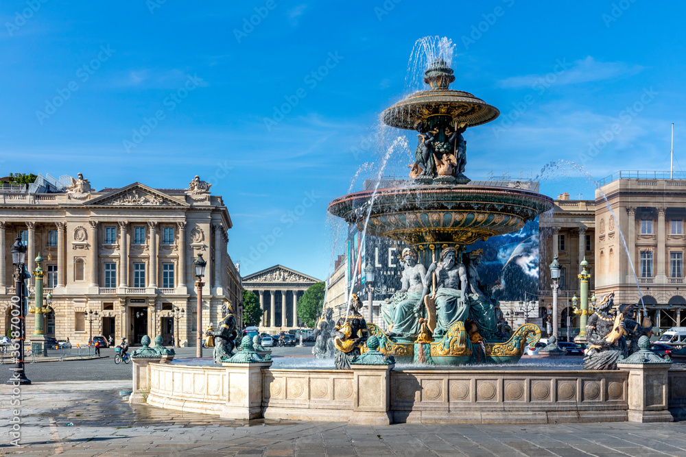 Paris, France - June 23, 2020: Rivers Fountain at Place de la Concorde with the Madeleine church in the background in Paris