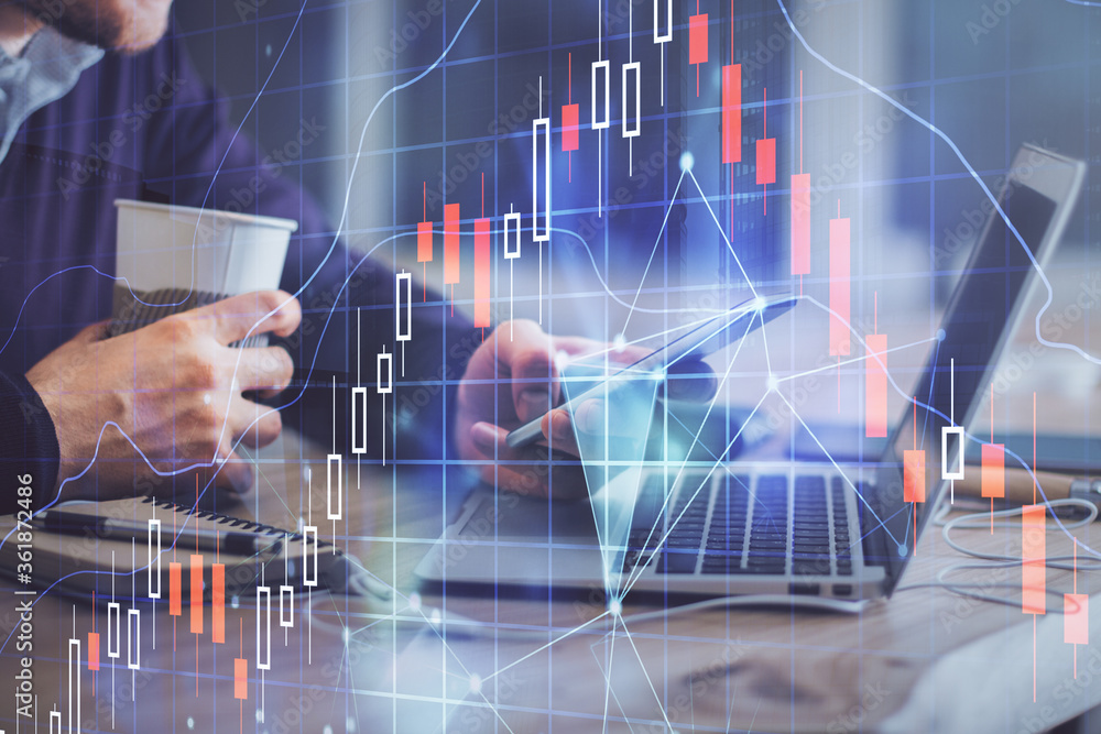 Double exposure of man's hands holding and using a phone and financial graph drawing. Analysis concept. Double exposure of man's hands holding and using a phone and financial graph drawing. Analysis concept.