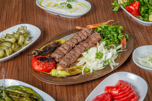 Turkish Urfa Kebab Skewer Dinner on Wooden Background