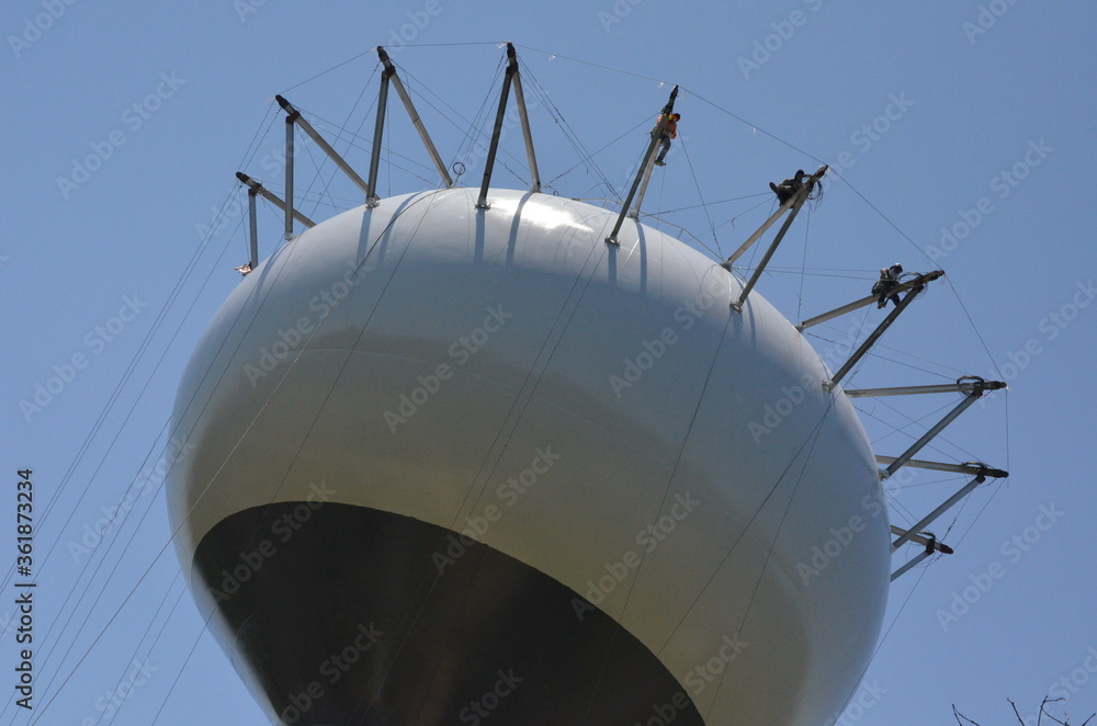 workers rigging on a tower